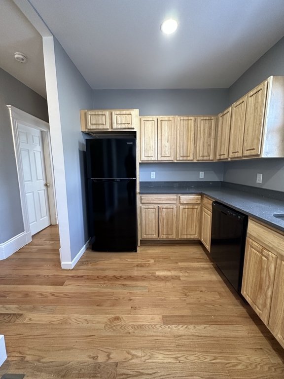 35 Harvard Street, Unit 2 Boston, MA 02124 - Photo 3 of 22 a kitchen with granite countertop a refrigerator and a sink