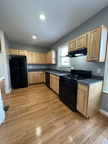 a kitchen with stainless steel appliances granite countertop a stove a sink and a refrigerator