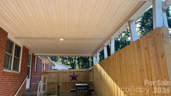 a view of balcony with wooden floor and fence
