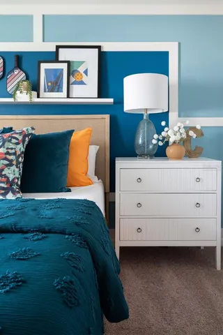 a bedroom with a bed and a dresser in it