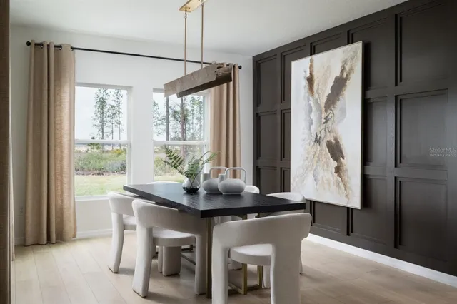 a dining room with furniture and window