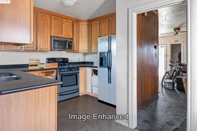 a kitchen with stainless steel appliances granite countertop a refrigerator stove and sink