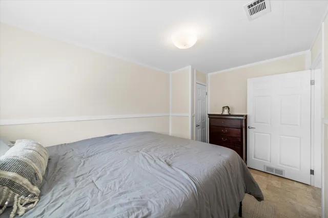 a picture of a room with a white wall and a refrigerator
