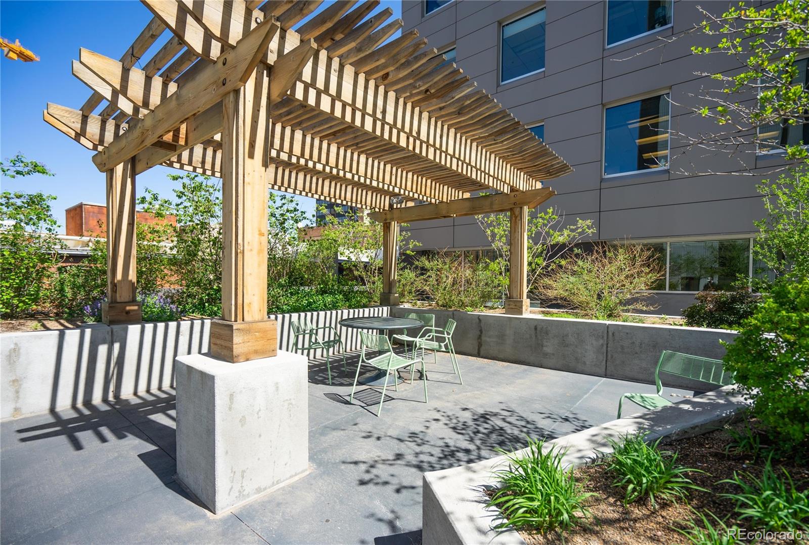 1625 Larimer Street, Unit 905 Denver, CO 80202 - Photo 9 of 12 a view of a patio with couches table and chairs and potted plants