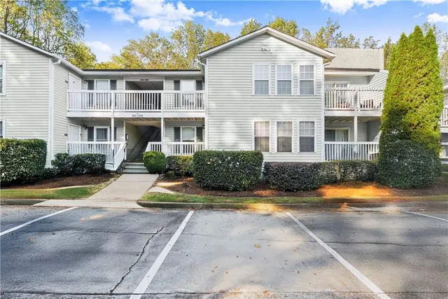 a view of a house with swimming pool and sitting area