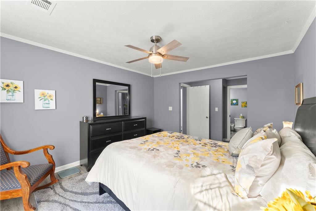 1997 Brian Way Decatur, GA 30033 - Photo 15 of 27 a bedroom with a bed and a chandelier