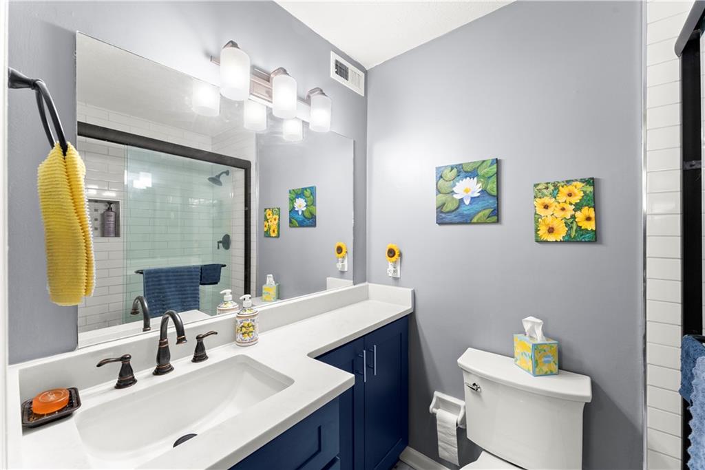 1997 Brian Way Decatur, GA 30033 - Photo 16 of 27 a bathroom with a sink vanity mirror and toilet