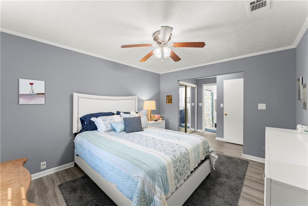 1997 Brian Way Decatur, GA 30033 - Photo 18 of 27 a bedroom with a bed and a chandelier