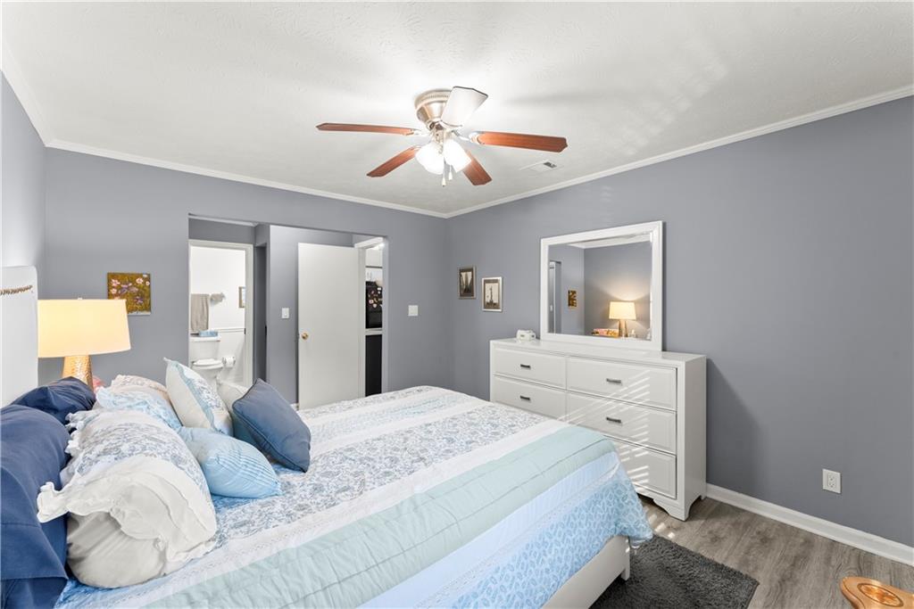 1997 Brian Way Decatur, GA 30033 - Photo 19 of 27 a bedroom with a bed and a chandelier