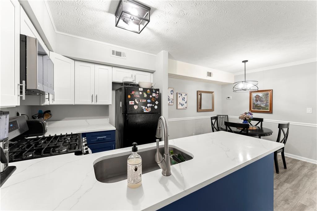 1997 Brian Way Decatur, GA 30033 - Photo 10 of 27 a kitchen with a sink a stove and chairs