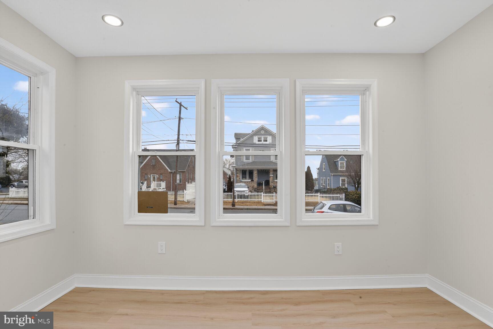 4013 4th Street Baltimore, MD 21225 - Photo 11 of 35 a view of an empty room with wooden floor and a window