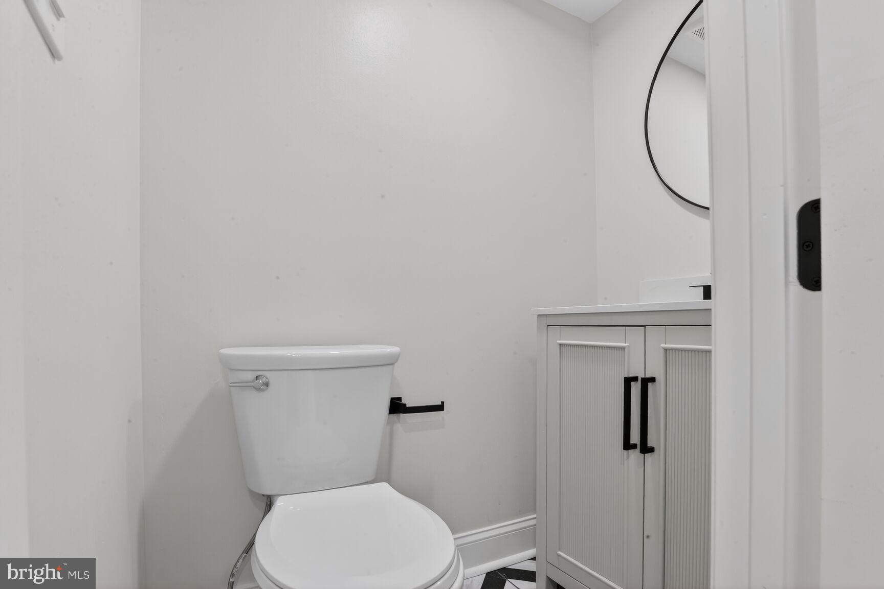 4013 4th Street Baltimore, MD 21225 - Photo 20 of 35 a white toilet sitting next to a shower