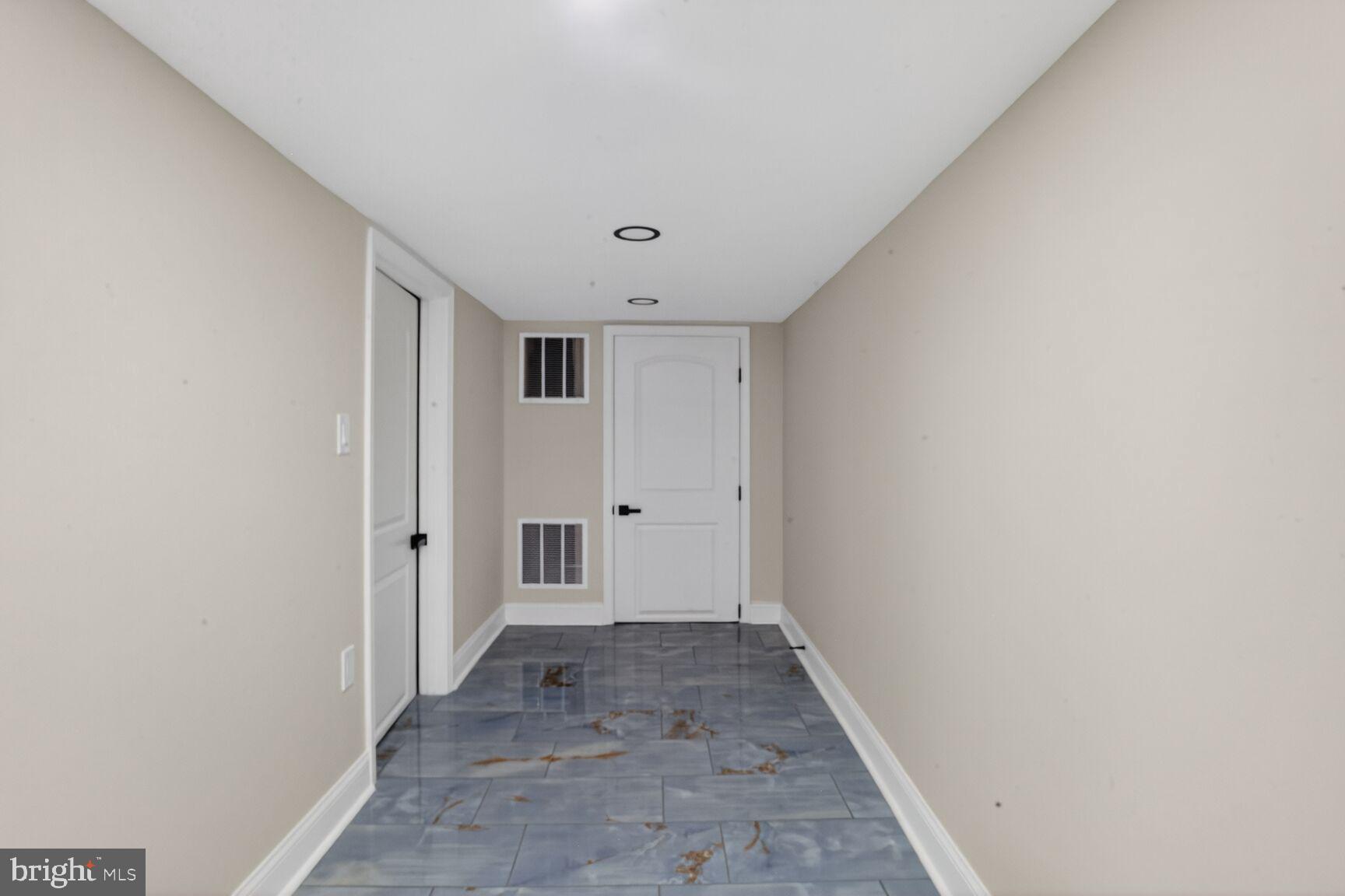 4013 4th Street Baltimore, MD 21225 - Photo 21 of 35 a view of a hallway with wooden shelves