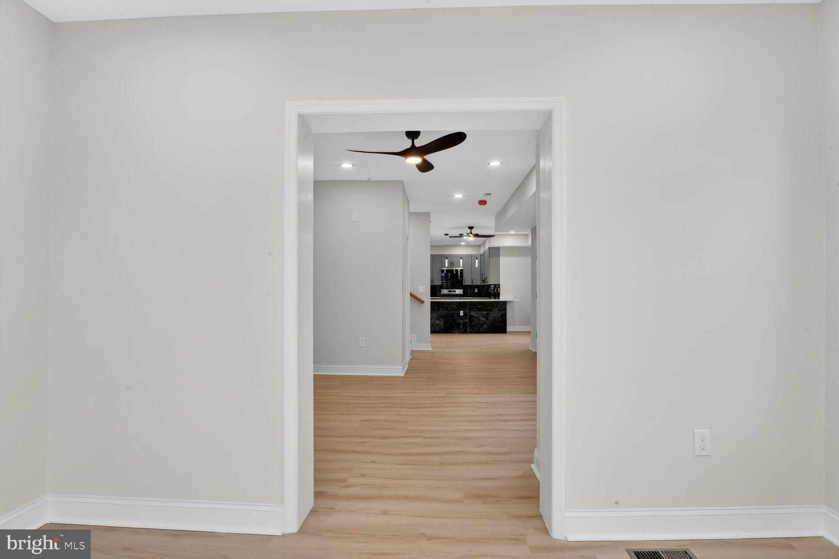 4013 4th Street Baltimore, MD 21225 - Photo 24 of 35 a view of a hallway with a stove and a refrigerator