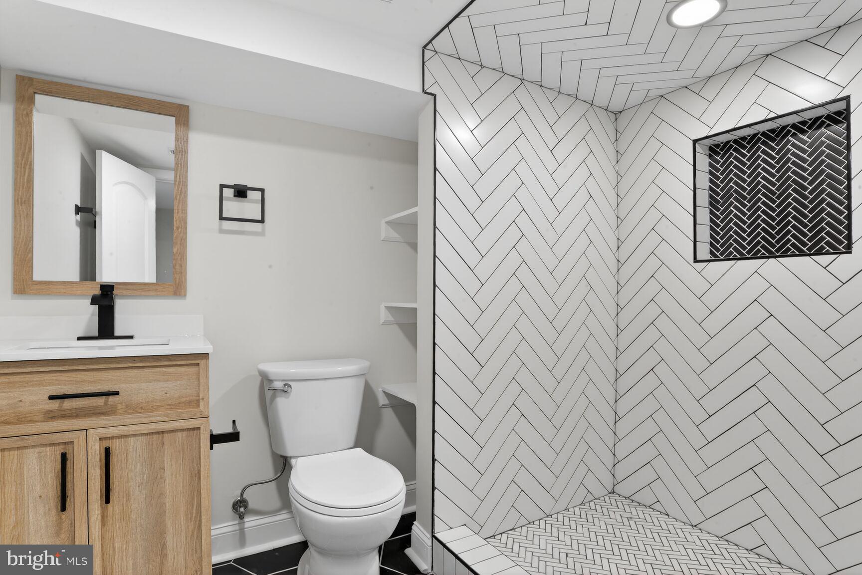 4013 4th Street Baltimore, MD 21225 - Photo 25 of 35 a bathroom with a sink a toilet and a mirror