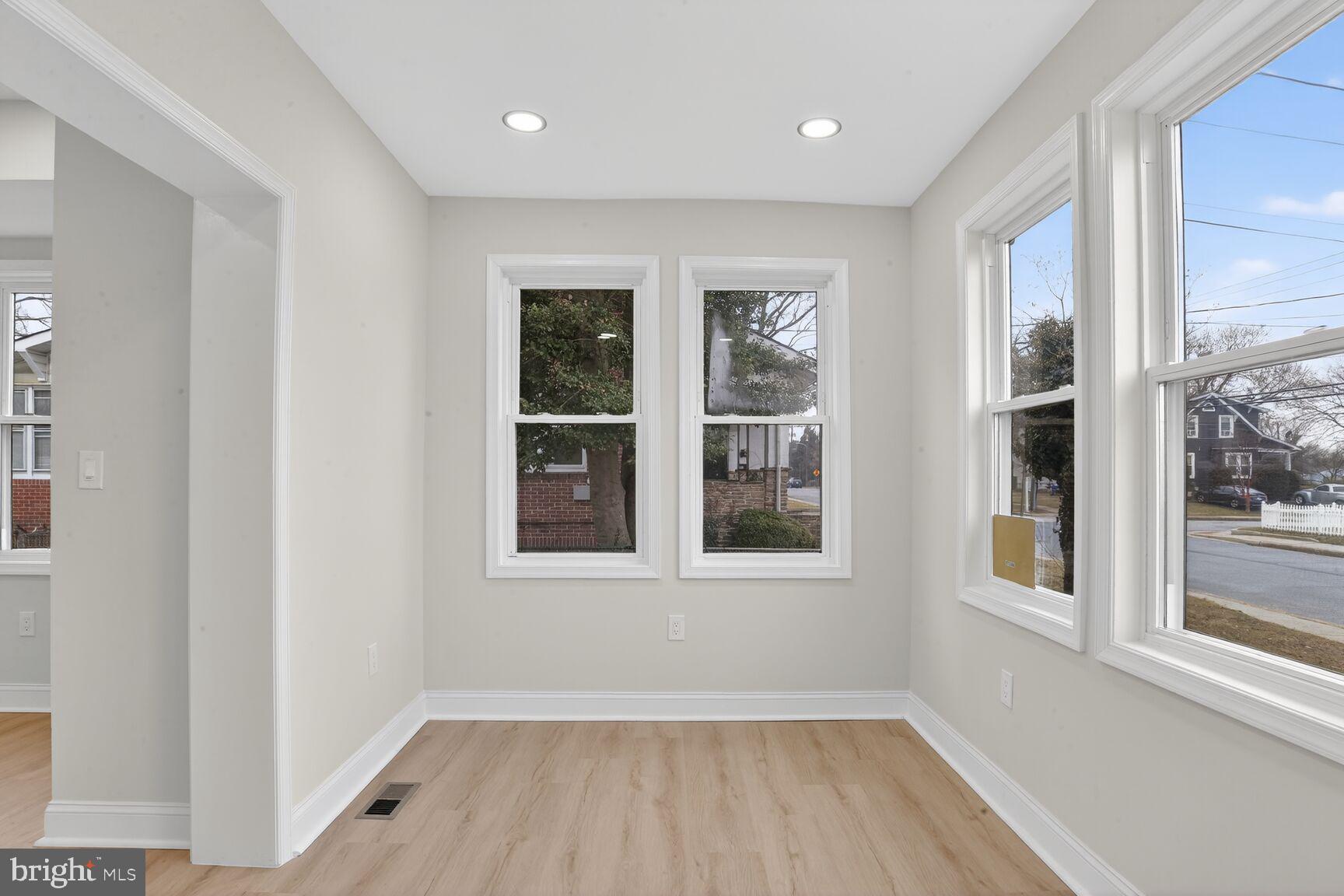 4013 4th Street Baltimore, MD 21225 - Photo 3 of 35 a view of an empty room with wooden floor and a window