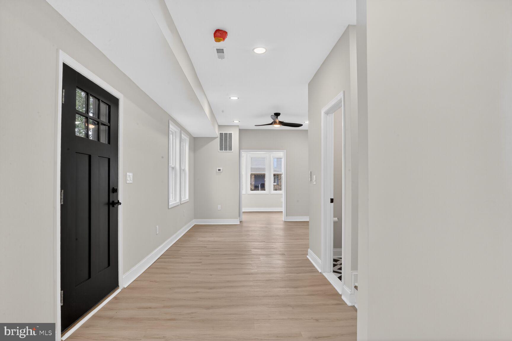 4013 4th Street Baltimore, MD 21225 - Photo 6 of 35 a view of a hallway with wooden floor and a bathroom