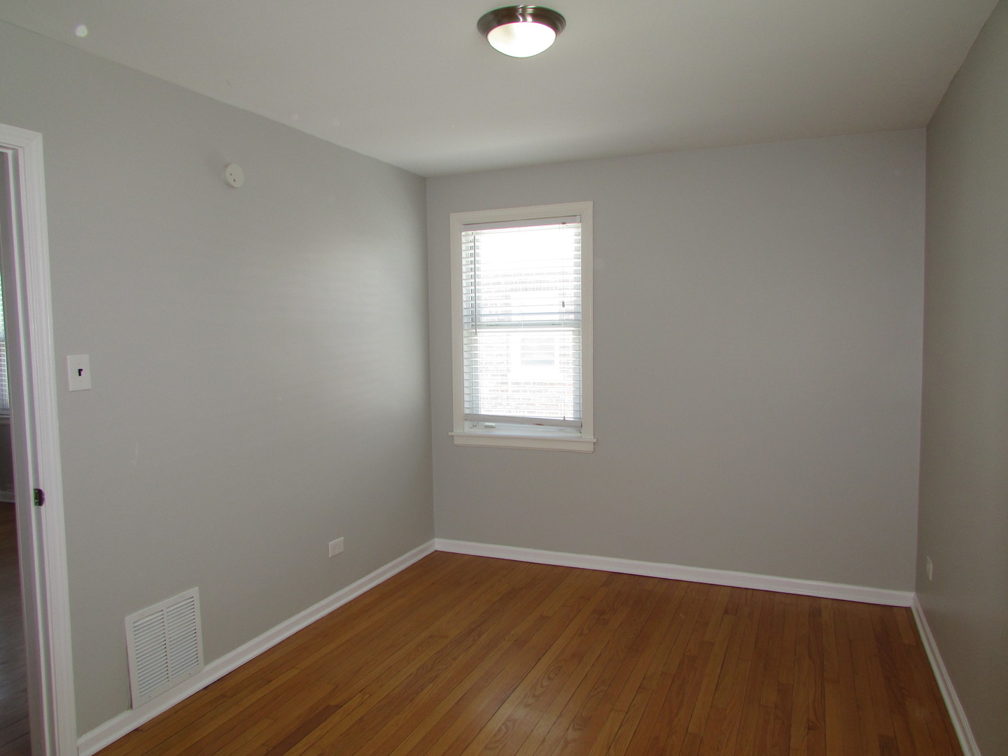 309 East Golf Road Des Plaines, IL 60016 - Photo 2 of 27 a view of an empty room with wooden floor and a window