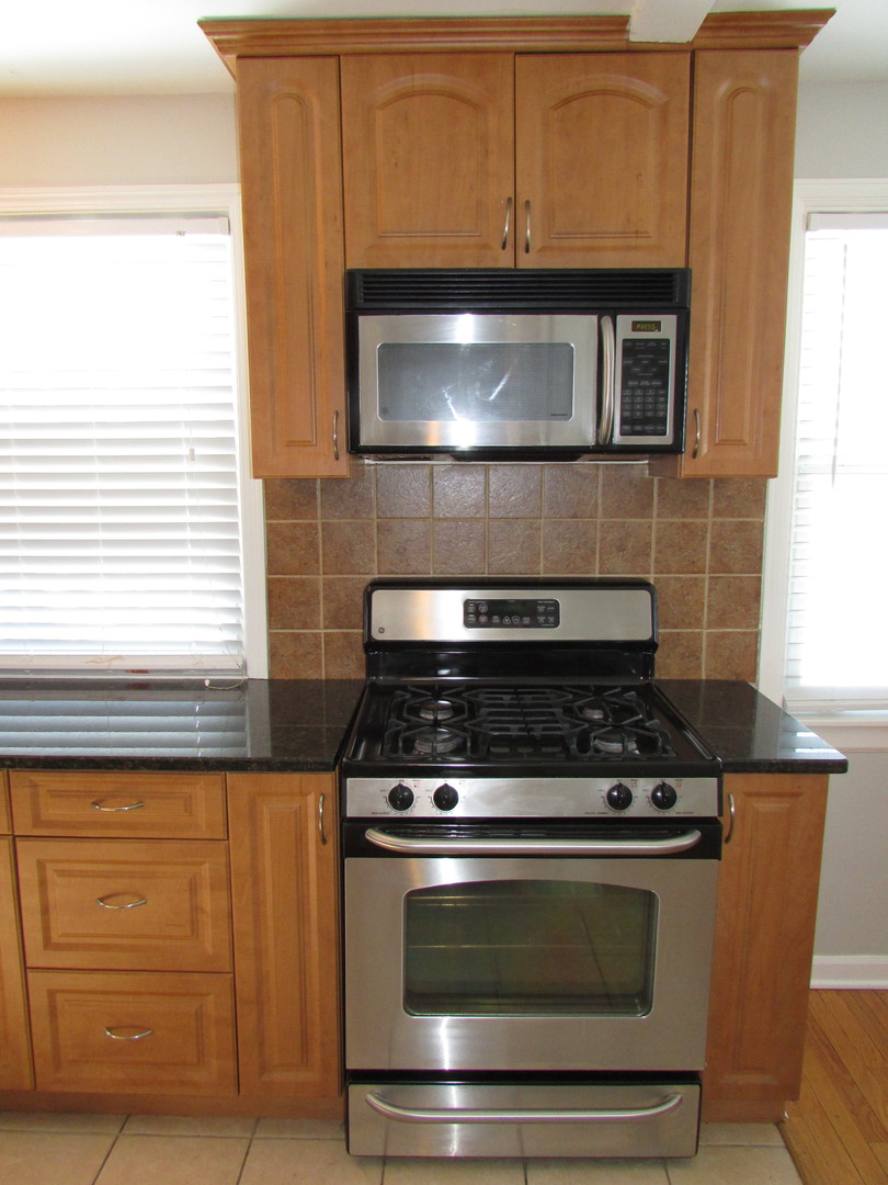 309 East Golf Road Des Plaines, IL 60016 - Photo 14 of 27 a stove top oven sitting inside of a kitchen
