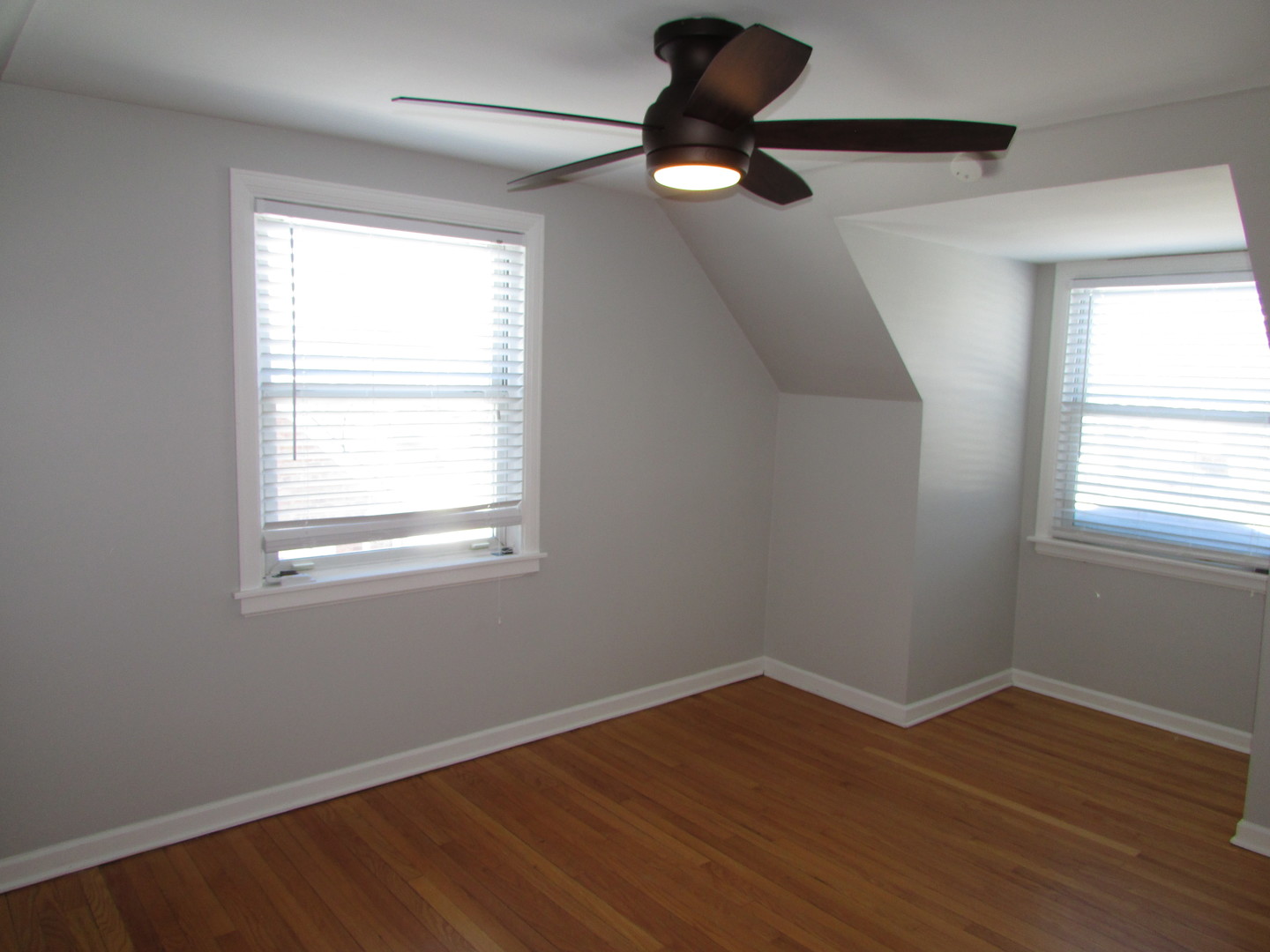 309 East Golf Road Des Plaines, IL 60016 - Photo 16 of 27 a view of an empty room with wooden floor and a window