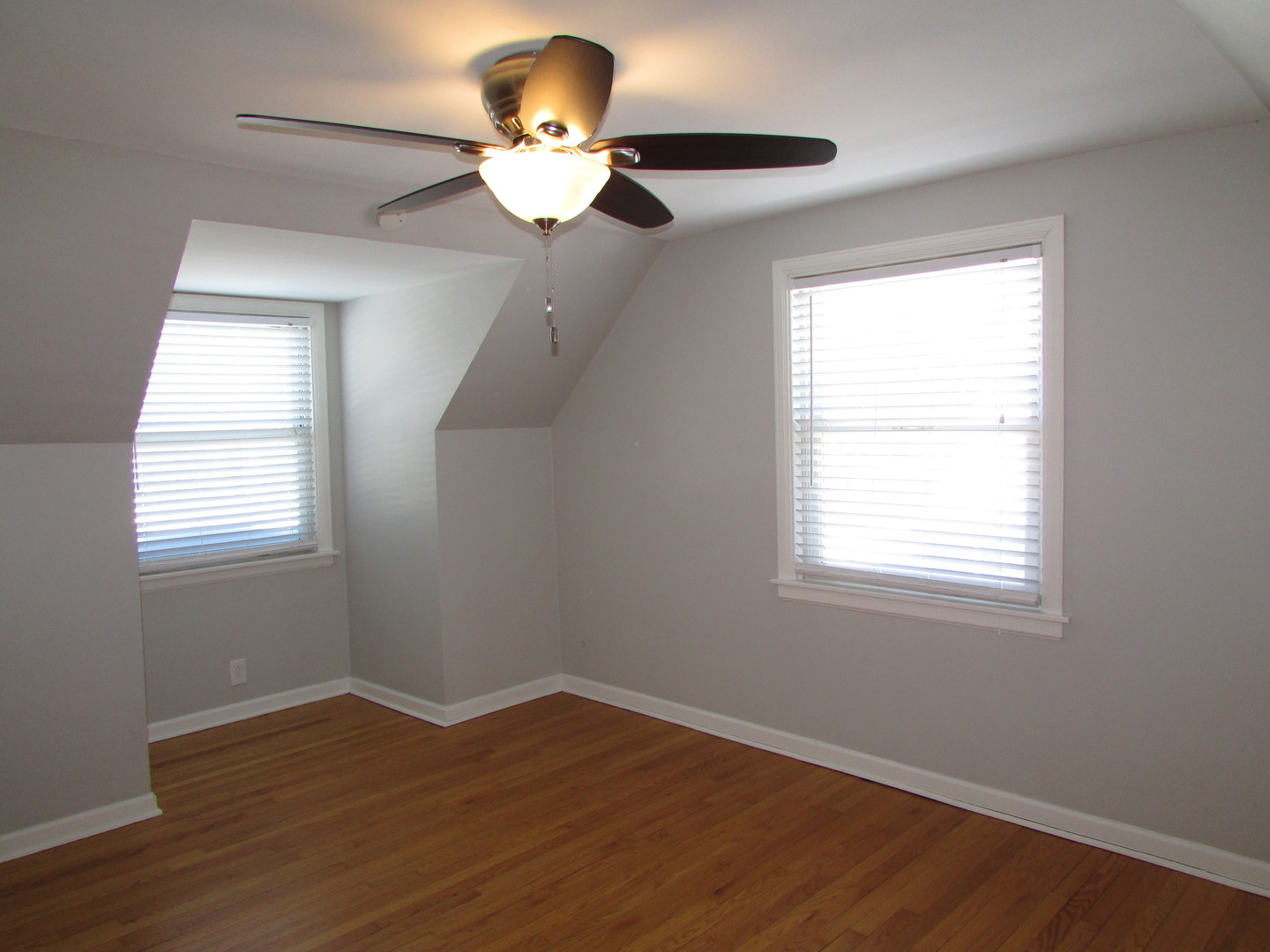 309 East Golf Road Des Plaines, IL 60016 - Photo 18 of 27 a view of an empty room with wooden floor and a window