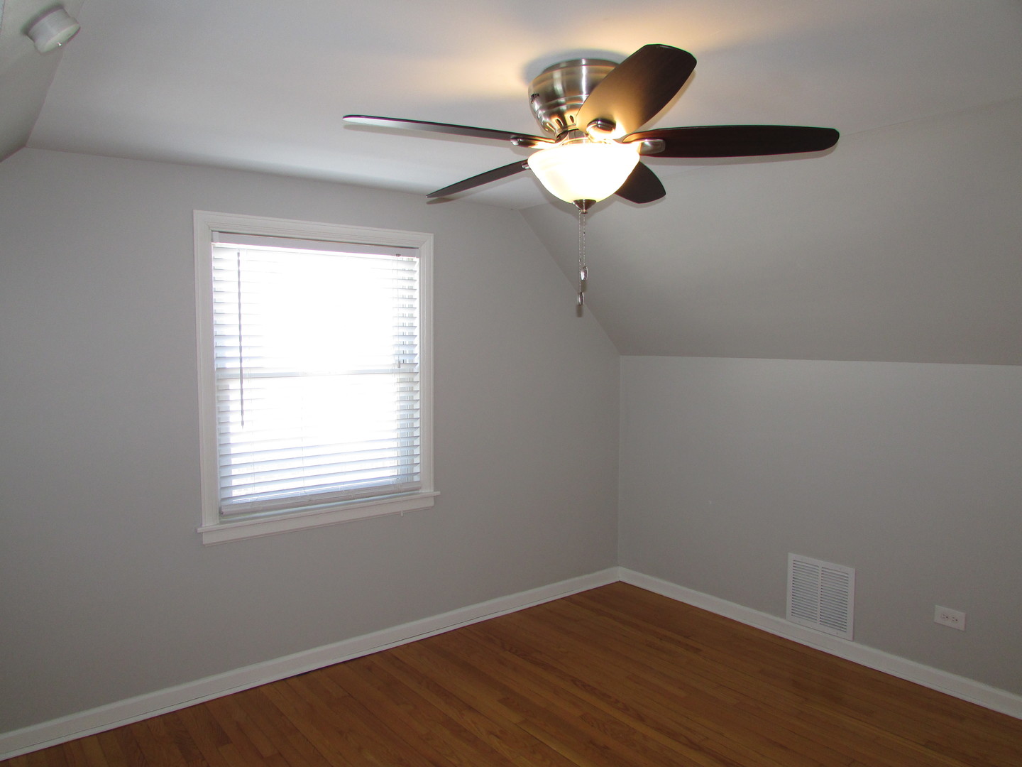 309 East Golf Road Des Plaines, IL 60016 - Photo 20 of 27 an empty room with wooden floor fan and windows