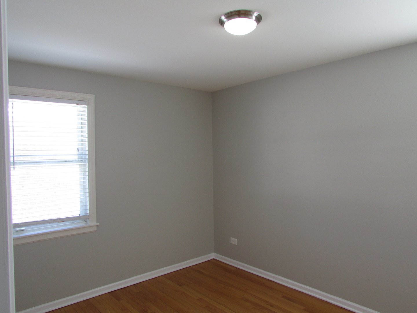 309 East Golf Road Des Plaines, IL 60016 - Photo 5 of 27 a view of an empty room with wooden floor and a window
