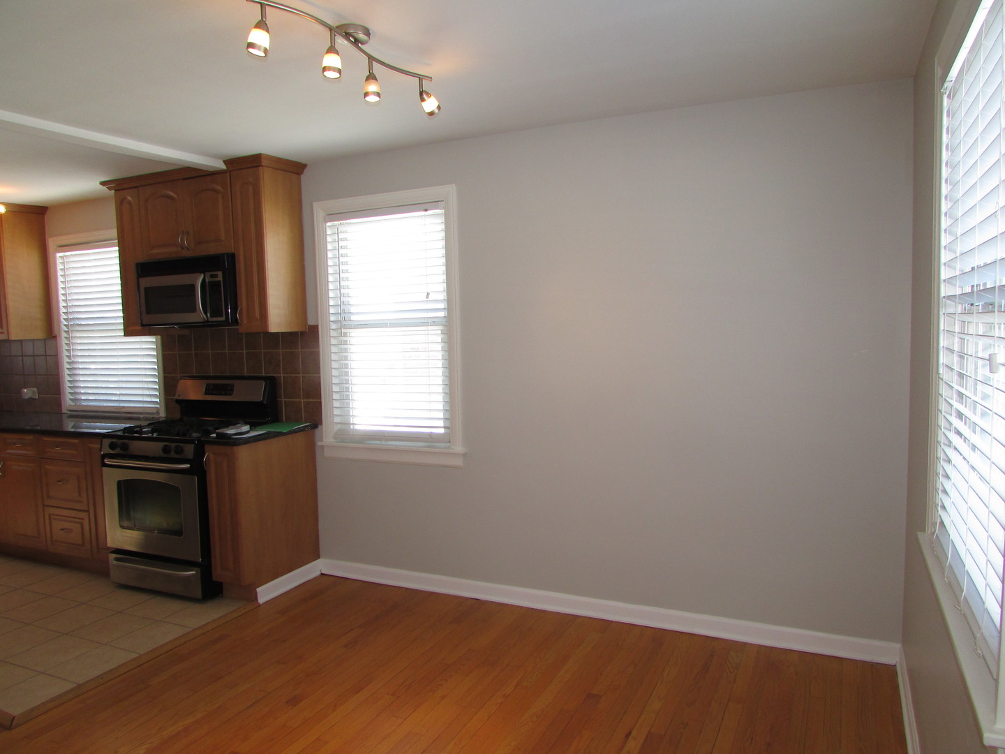 309 East Golf Road Des Plaines, IL 60016 - Photo 8 of 27 an empty room with wooden floor and a window