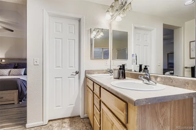 a bathroom with a sink vanity and a mirror