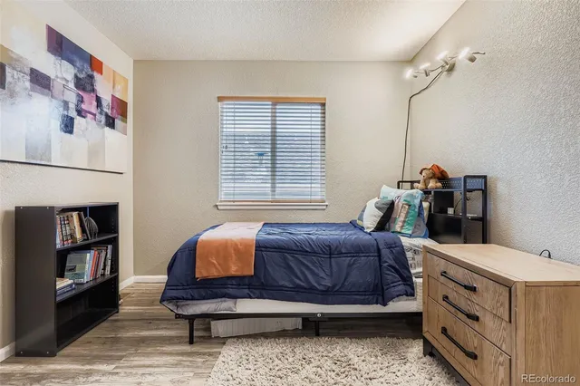 a bedroom with a bed and a book shelf