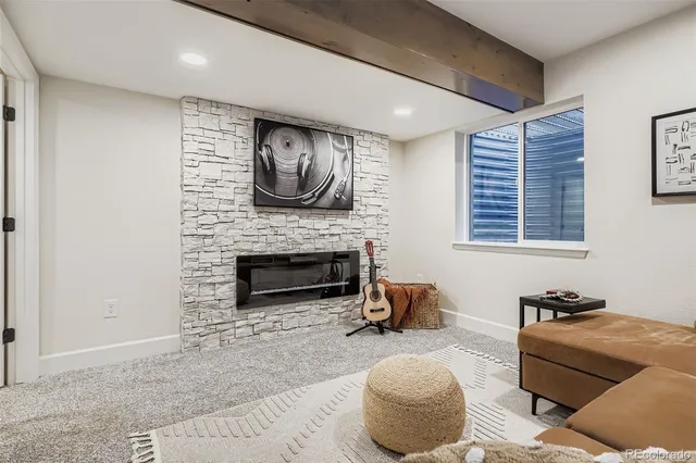 a living room with furniture a flat screen tv and a fireplace
