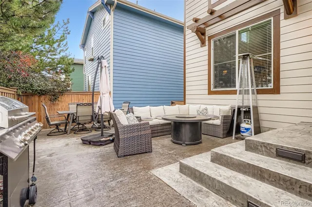 a view of a patio with dining table and chairs