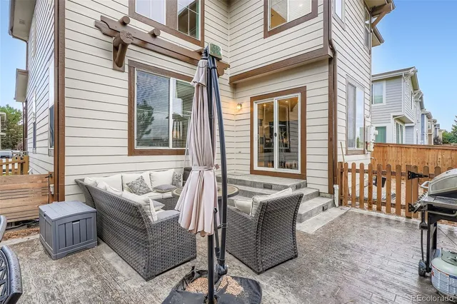 a view of a house with a backyard and couches
