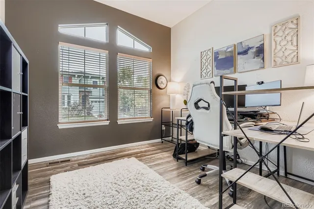 a view of a workspace with furniture and a window