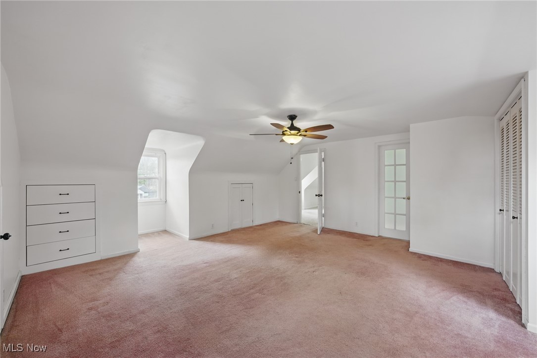 28575 White Road Wickliffe, OH 44092 - Photo 27 of 49 Additional living space featuring light colored carpet, a ceiling fan, and vaulted ceiling