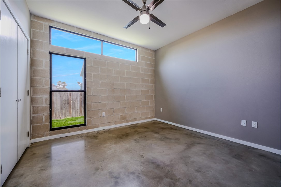 306 Easy Street, Unit B Corpus Christi, TX 78418 - Photo 12 of 24 an empty room with windows and ceiling fan