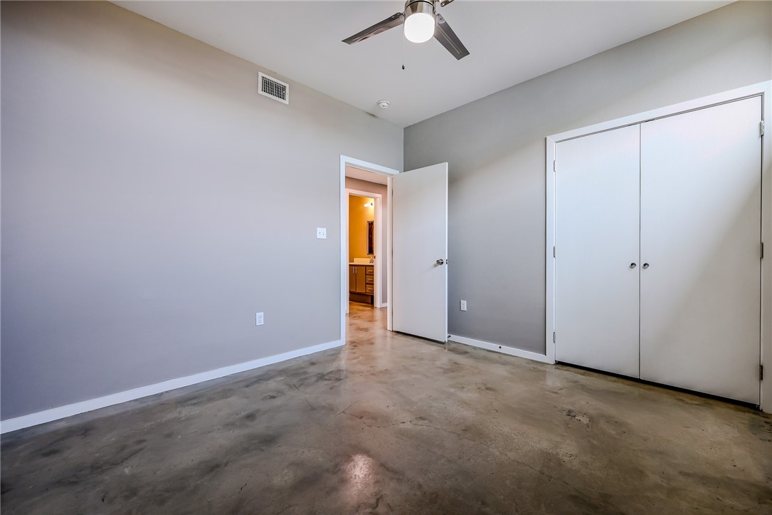 306 Easy Street, Unit B Corpus Christi, TX 78418 - Photo 13 of 24 an empty room with a ceiling fan and carpet