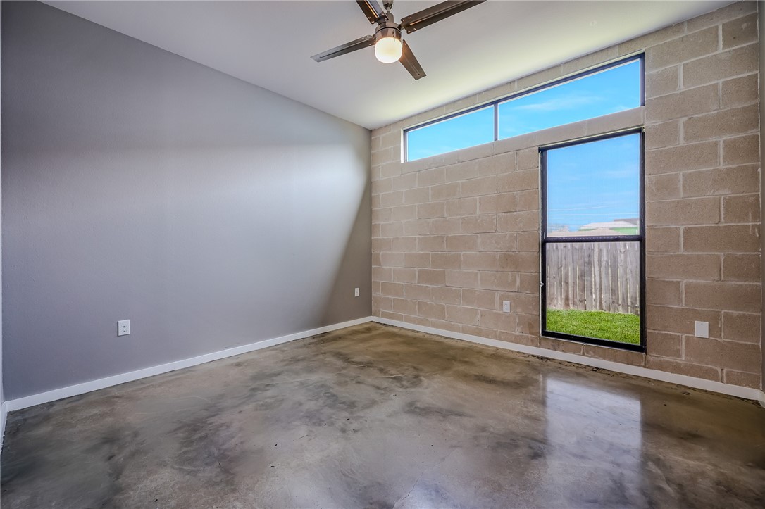 306 Easy Street, Unit B Corpus Christi, TX 78418 - Photo 14 of 24 an empty room with a window and a ceiling fan
