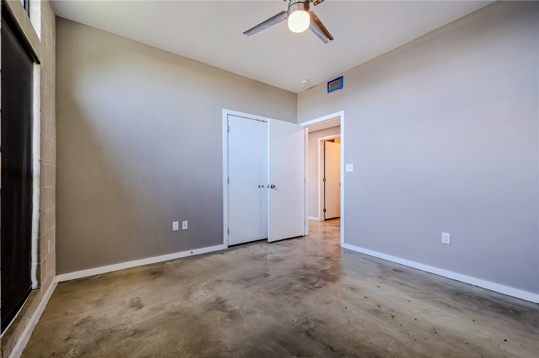 306 Easy Street, Unit B Corpus Christi, TX 78418 - Photo 15 of 24 an empty room with a ceiling fan and a window
