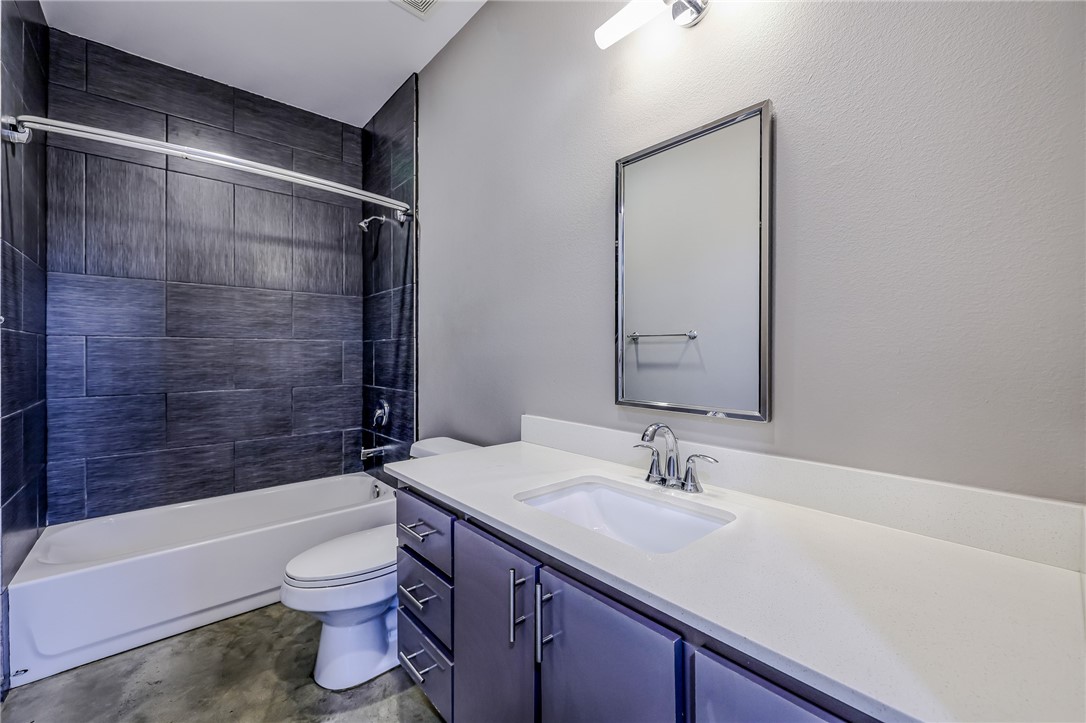 306 Easy Street, Unit B Corpus Christi, TX 78418 - Photo 16 of 24 a bathroom with a granite countertop sink toilet and shower