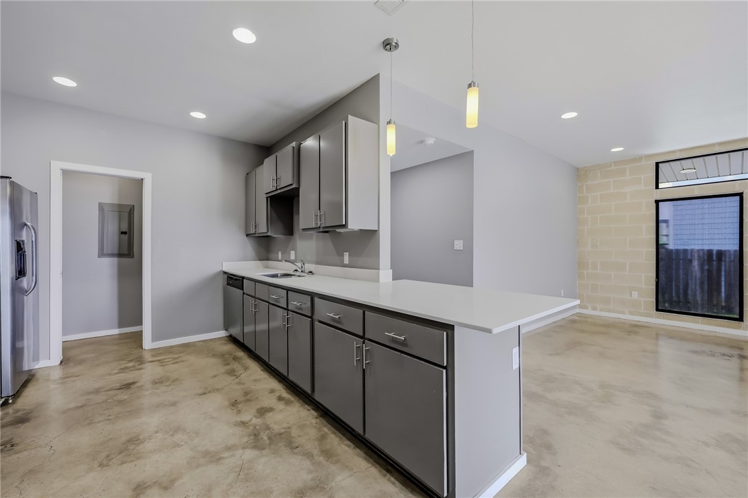 306 Easy Street, Unit B Corpus Christi, TX 78418 - Photo 6 of 24 a large kitchen with a sink and stainless steel appliances