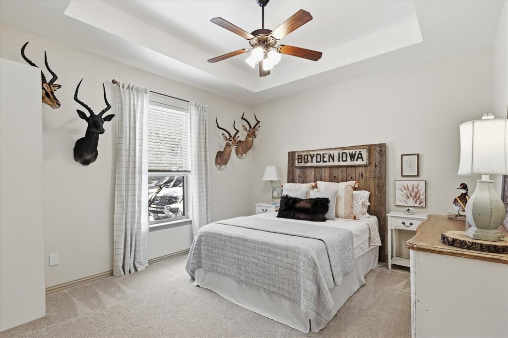 149 Overton Ridge Circle Weatherford, TX 76088 - Photo 28 of 39 Tray ceiling with a ceiling fan light fixture, carpet flooring, and a single window with blinds