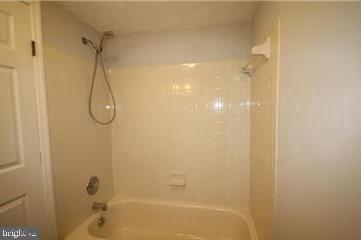 603 Himes Avenue, Unit 106 Frederick, MD 21703 - Photo 11 of 13 a bathroom with a glass shower door