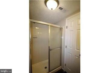 603 Himes Avenue, Unit 106 Frederick, MD 21703 - Photo 12 of 13 a bathroom with a glass shower door