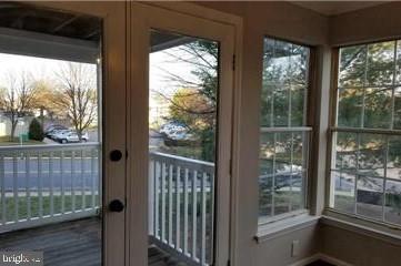 603 Himes Avenue, Unit 106 Frederick, MD 21703 - Photo 8 of 13 a view of a glass door with a yard from a window