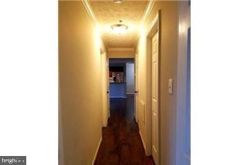 603 Himes Avenue, Unit 106 Frederick, MD 21703 - Photo 9 of 13 a view of a hallway with wooden floor