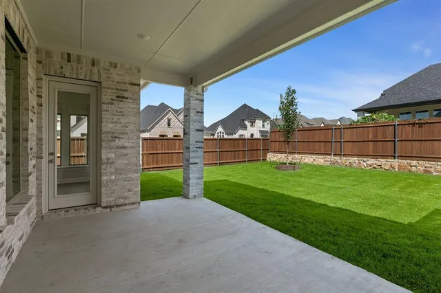 a view of a house with a yard and entertaining space