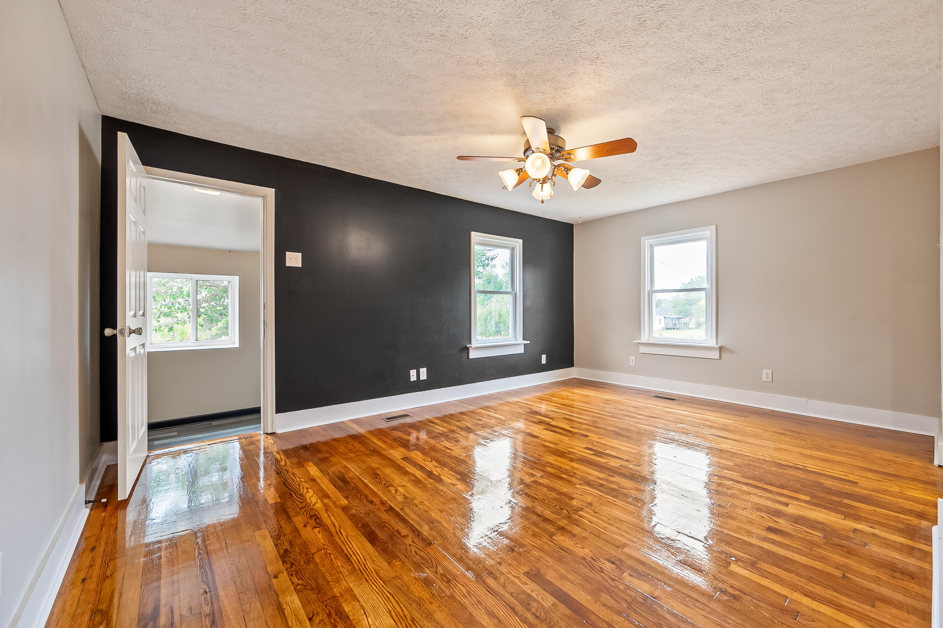 306 Lester Street Radford, VA 24141 - Photo 10 of 51 a view of an empty room with window and wooden floor