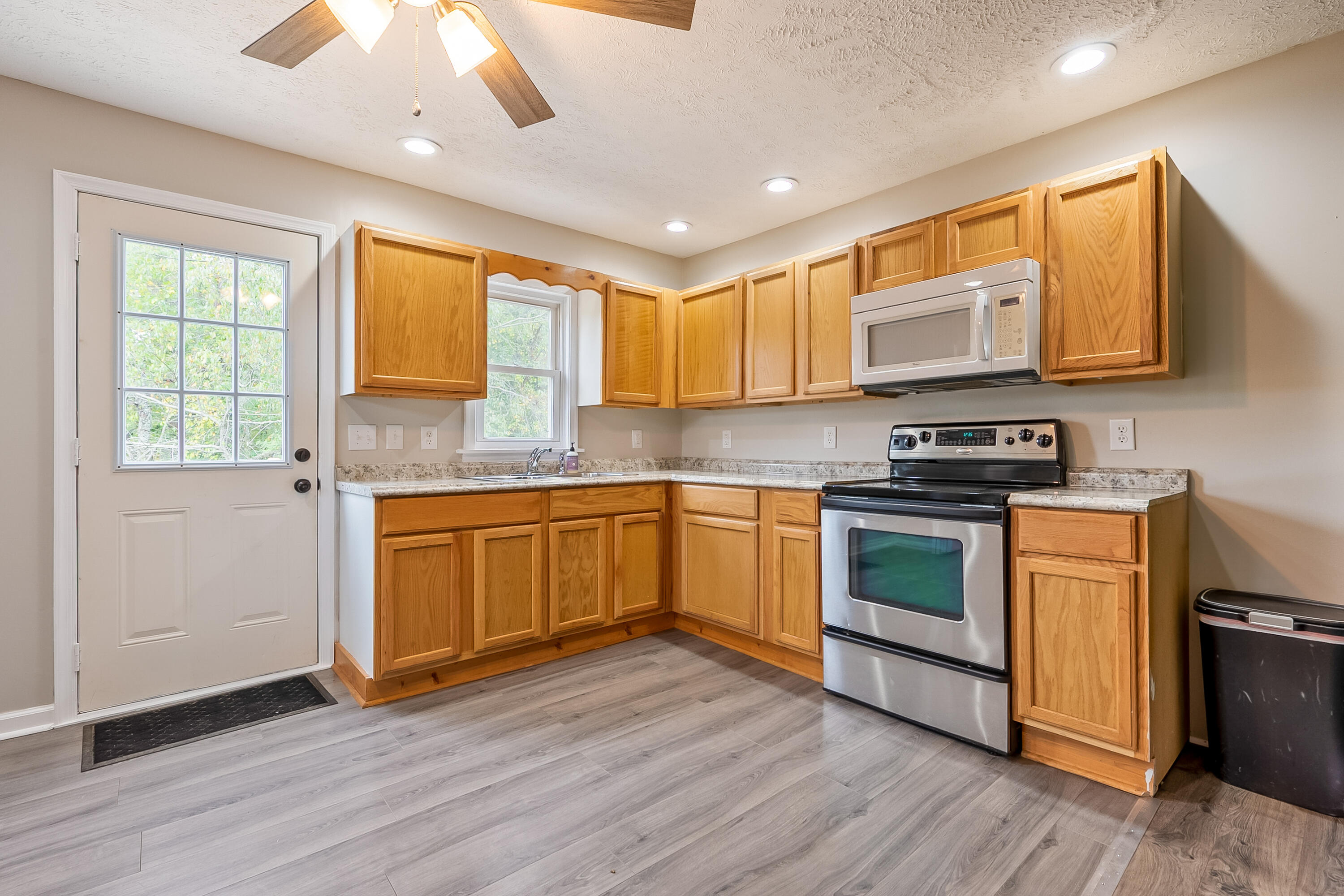 306 Lester Street Radford, VA 24141 - Photo 11 of 51 a kitchen with stainless steel appliances granite countertop a stove a sink and a microwave