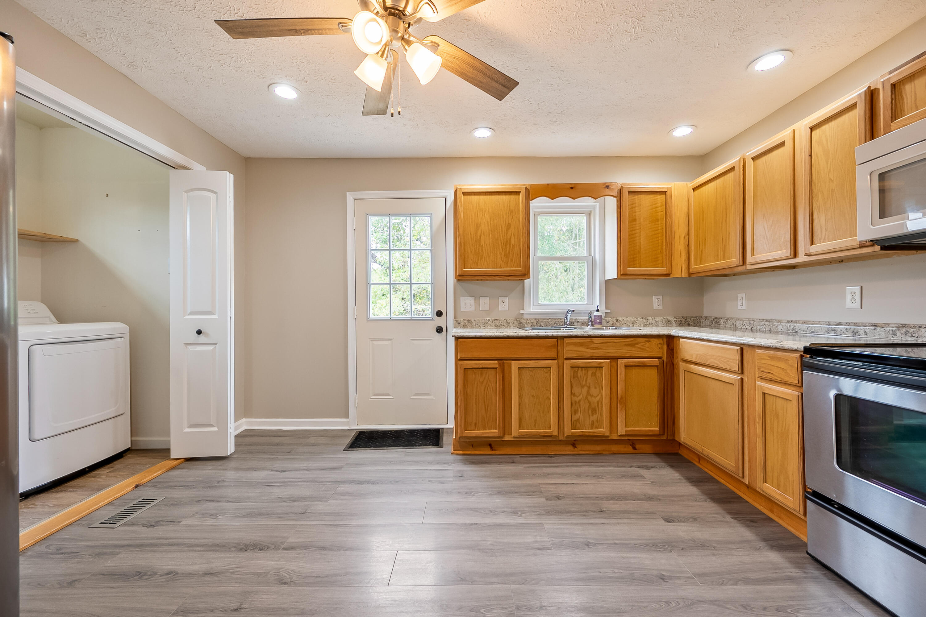 306 Lester Street Radford, VA 24141 - Photo 12 of 51 a kitchen with granite countertop a stove a sink and a microwave